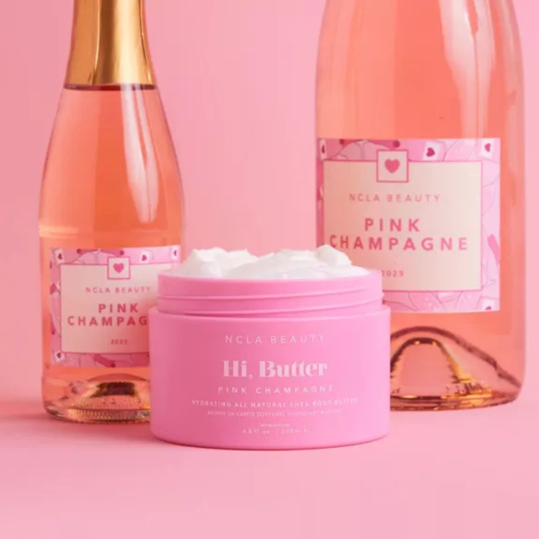 NCLA Beuaty body butter pink champagne with pink champagne in the background